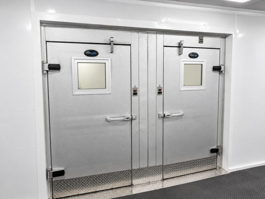 Walk-in cooler and freezer doors inside KCI’s 2,500 sq. ft. five-wide temporary kitchen facility at Citizens Memorial Hospital.